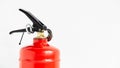 Red fire extinguisher on a white wall background Royalty Free Stock Photo