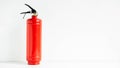 Red fire extinguisher on a white wall background Royalty Free Stock Photo