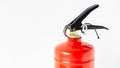 Red fire extinguisher on a white wall background Royalty Free Stock Photo