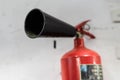 Red fire extinguisher on white wall background Royalty Free Stock Photo