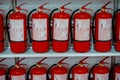 Red fire extinguishers stand in a row Royalty Free Stock Photo