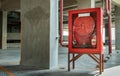A red fire fighting equipment cabinet or fire extinguishing cabinet of fire protection set is located in condominium car parking