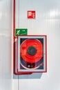 A red fire hydrant box is mounted on a wall, part of a building's fire safety system Royalty Free Stock Photo