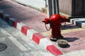 A red fire hydrant installed on footpath Royalty Free Stock Photo
