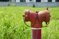 Red fire hydrant installed outside the building. Royalty Free Stock Photo