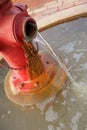 Red Fire Hydrant with Running Water pouring out Royalty Free Stock Photo