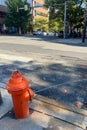 A red fire hydrant sits on the sidewalk in front of a building Royalty Free Stock Photo