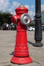 Red fire hydrant stands on city street Royalty Free Stock Photo