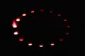 Red fire light shines through holes