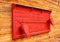 Red fire point stand mounted on wooden wall