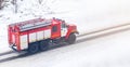 A red fire truck or Fire engine drives down a snowy street in winter Royalty Free Stock Photo