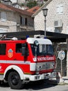 Red fire truck stands near a stone house