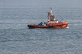 A Red fire tug boat equipped with saftey equipment