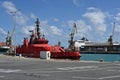 Red fireboat designed for fire extinguishing and firefighting of ships and port infrastructure is moored in passenger terminal. Royalty Free Stock Photo