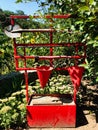 red firefighter shield with spade, sand box and bucket in the garden