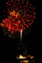 Red firework exploding above the Grand River on the 4th of July