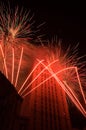 Red fireworks around a tall building Royalty Free Stock Photo