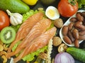 Red fish, avocado, kiwi nuts salad dieting on a black wooden background, healthy food Royalty Free Stock Photo