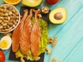 Red fish, avocado, kiwi nuts salad nutrition on a black wooden background, healthy food Royalty Free Stock Photo