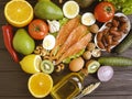 Red fish, avocado, lemon, kiwi, nuts on a dark wooden background Royalty Free Stock Photo