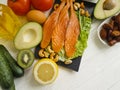 Red fish, avocado, nuts antioxidant lemon protein ingredient on a wooden background Royalty Free Stock Photo