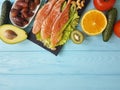 Red fish omega 3 , fresh avocado dinner nuts assortment on blue wooden, composition healthy food Royalty Free Stock Photo