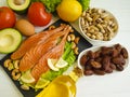 Red fish, avocado, nuts lemon protein ingredient on a wooden background Royalty Free Stock Photo