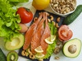 Red fish, avocado, tomato lemon ingredient dinner natural selection on white wooden background, healthy food Royalty Free Stock Photo