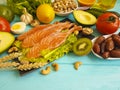 Red fish fillet avocado, kiwi nuts salad nutrition on a black wooden background, healthy food Royalty Free Stock Photo