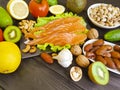 Red fish natural , avocado, lemon, kiwi, nuts ingredient on a dark wooden background Royalty Free Stock Photo