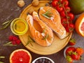 Red fish steak, tomato appetizer on a concrete background