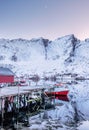 Red fishing boat anchored at pier with mountain reflection in ar Royalty Free Stock Photo