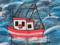 Red fishing boat painted on a wall in Howth Ireland