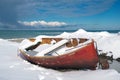 Red fishing boats covered with snow