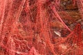 A red fishing net hanging on a wall Royalty Free Stock Photo