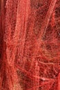 A red fishing net hanging on a wall Royalty Free Stock Photo