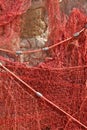 A red fishing net hanging on a wall Royalty Free Stock Photo