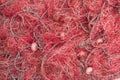 Red fishing net heap at the harbor. Royalty Free Stock Photo