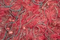 Red fishing net heap at the harbor. Royalty Free Stock Photo