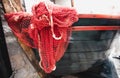 Red fishnet lying blue wooden rowboat Royalty Free Stock Photo