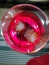 Red fizzy drink in glass with ice cubes Royalty Free Stock Photo