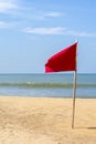 Red flag on the beach with a very calm ocean Royalty Free Stock Photo