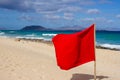 Red flag on beach. Warning sign. Dangerous swim. Safety guard, lifebuoy, lifeguard, life guard. Vacation at ocean. Royalty Free Stock Photo