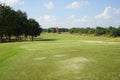 Red flag at the beautiful golf course at the sunrise time. Beautiful golf course in a sunny day. Background evening golf course Royalty Free Stock Photo