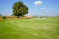 Red flag at the beautiful golf course at the sunrise time. Beautiful golf course in a sunny day. Background evening golf course Royalty Free Stock Photo