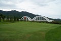 Red flag at the beautiful golf course with white bridge railway background Royalty Free Stock Photo