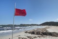 Red flag at beautiful white sandy beach at San Teodoro Sardinia. Royalty Free Stock Photo