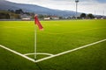 Red flag on corner kick in green artificial grass soccer field Royalty Free Stock Photo