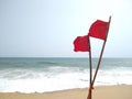 Red flag danger symbol on golden sand beach, Poovar Thiruvananthapuram Kerala