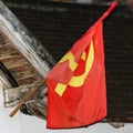 Red flag on the facade of the building, Luang Prabang, Laos. Close-up.